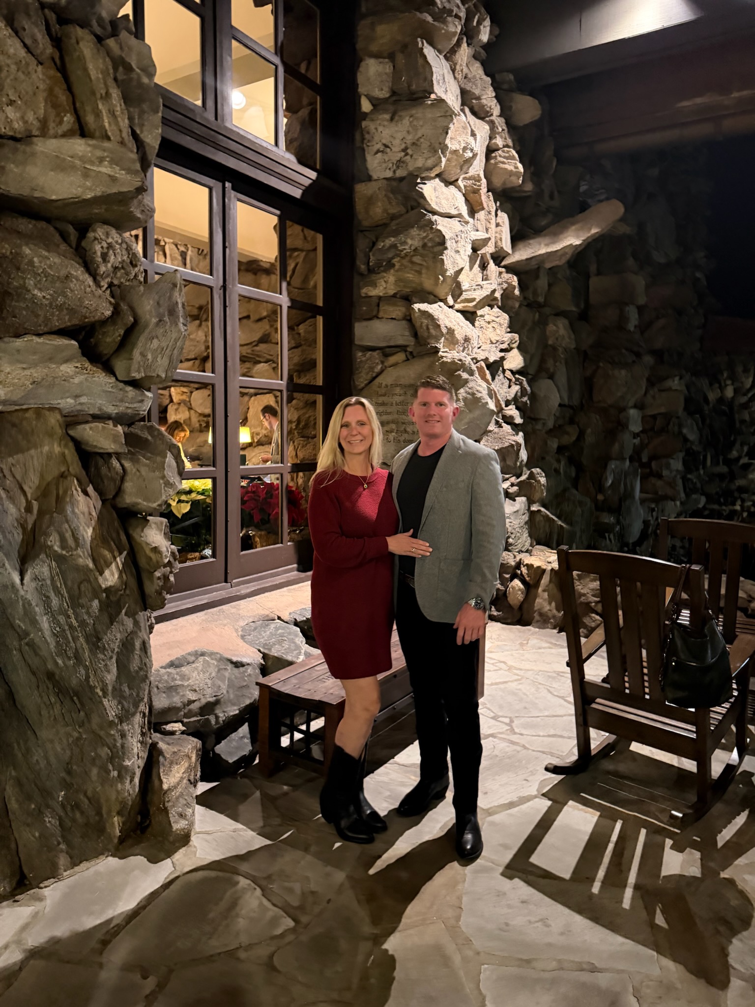 Jonathan Sharpe and his partner in a stone lodge interior